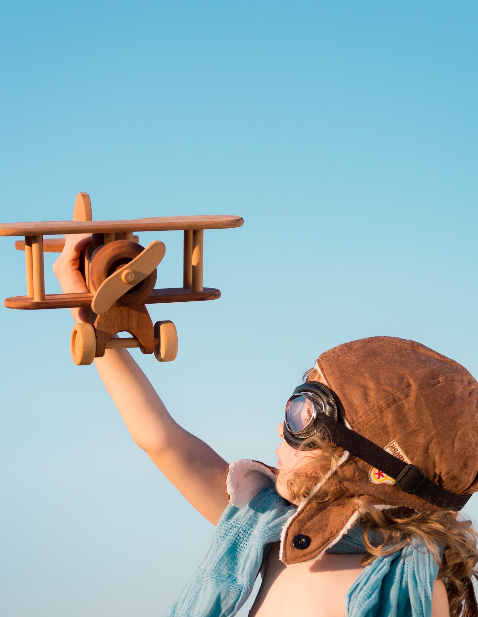 Happy kid playing with toy airplane